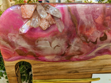 close up olive wood cheese board with pink cream and bronze resin