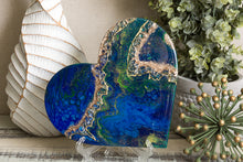 abstract blue green heart with stones