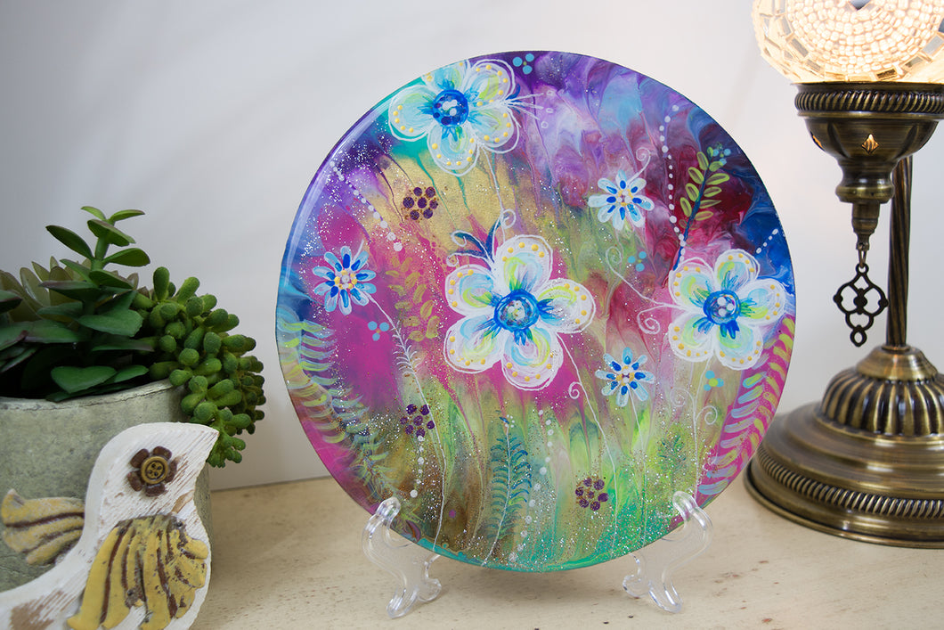 flowers layered on top of rainbow watercolor background round wood