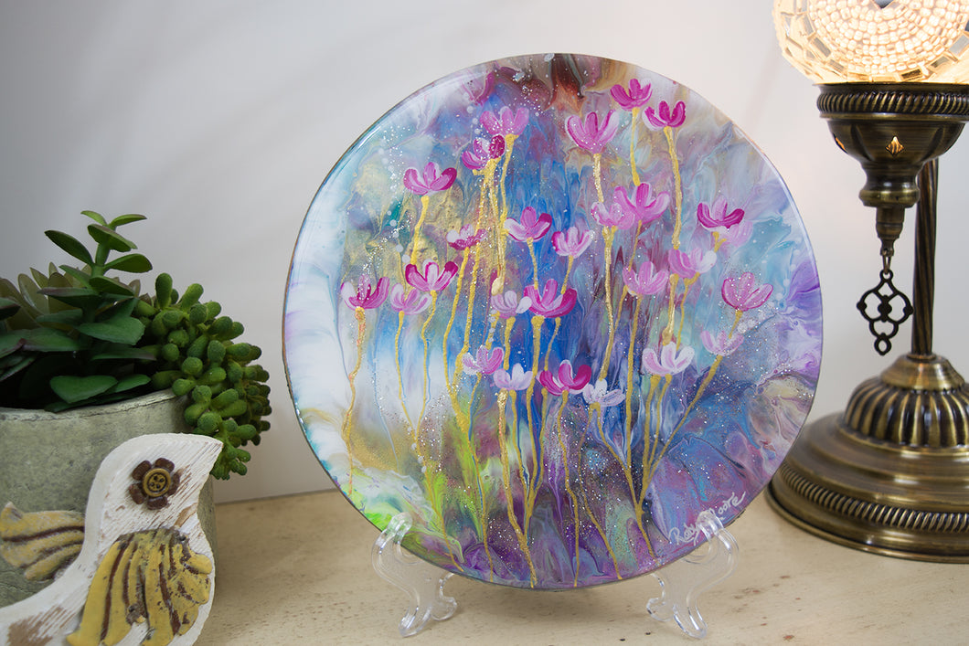 Abstract pink flowers on rainbow blue background gold stems on round wood with resin