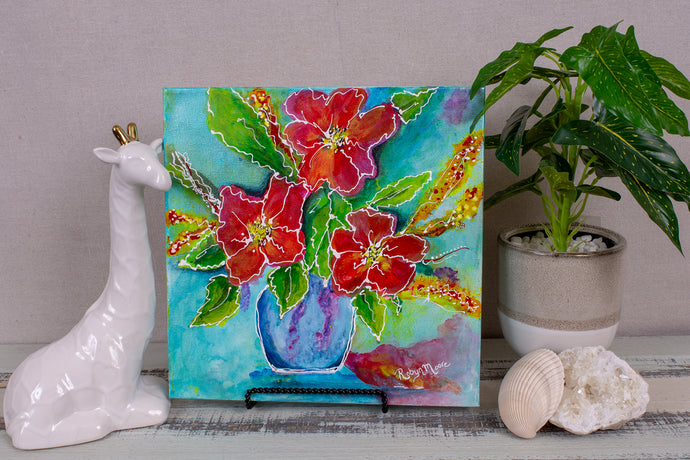 Bright red and orange flowers in a blue vase